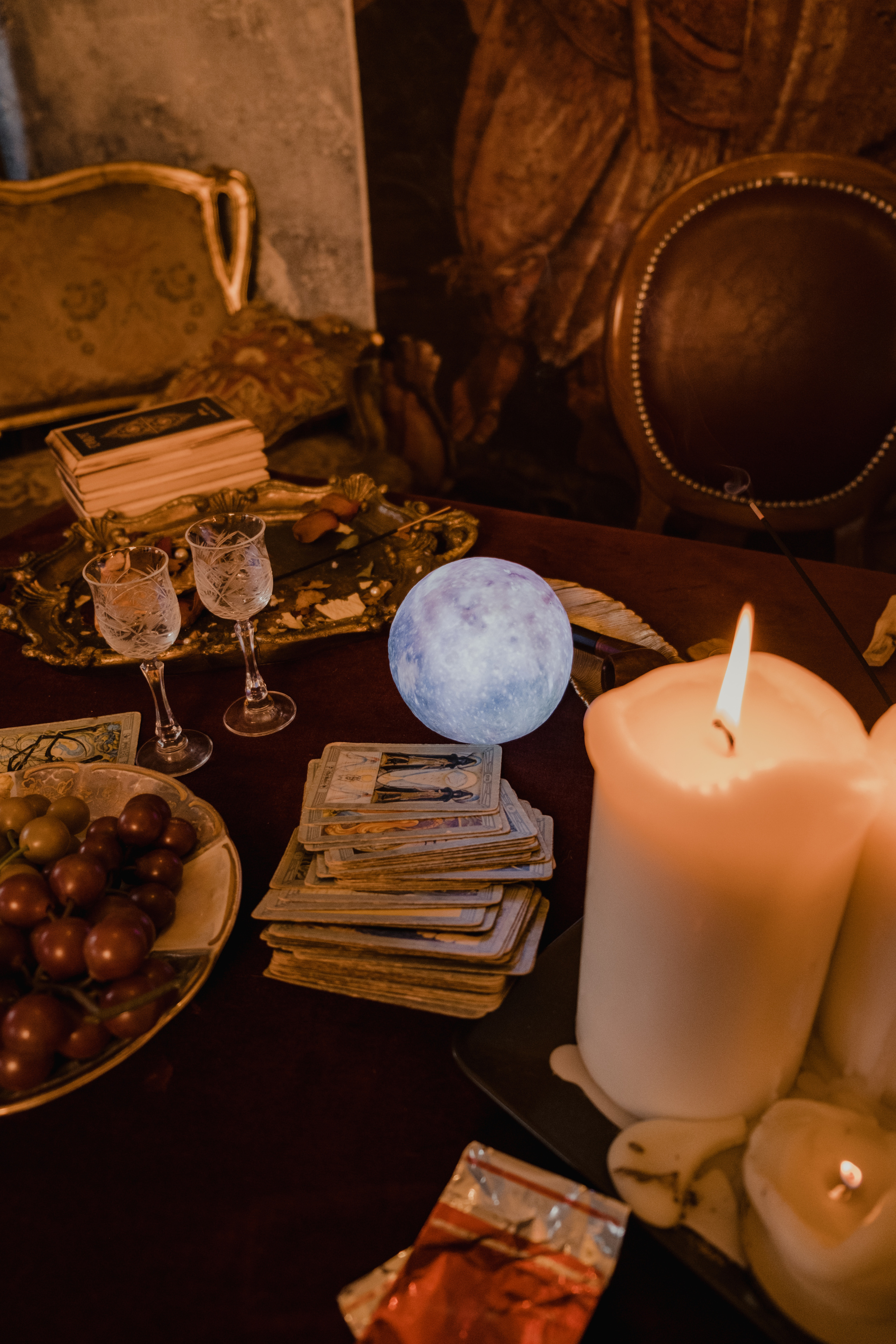 Tarot Cards, Crystal Ball, Candles, Glasses, and Fruits